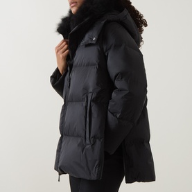 Model wearing Yves Salomon A-Line Down Jacket in black with removable shearling collar, front zip fastening and press-stud welt pockets