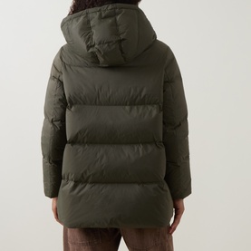 Model wearing Yves Salomon herbal tea puffer jacket, rear view, showing hooded back, quilted panels and mid-length fit