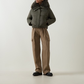 Model wearing Yves Salomon Cropped Down Jacket in Herbal Tea with removable shearling collar, styled with taupe cargo trousers and black loafers
