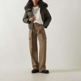 Model wearing Yves Salomon Cropped Down Jacket in Herbal Tea with removable shearling collar, styled with taupe cargo trousers and white tee.