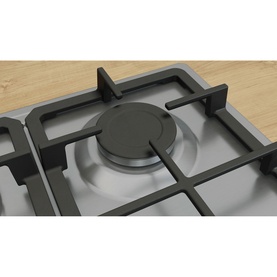 Bosch silver gas hob close-up showing central burner with cast iron pan supports and stainless steel surface