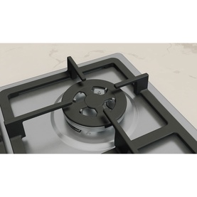 Neff silver gas hob close-up showing single burner with black cast iron pan support on marble surface