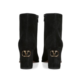 Valentino black suede ankle boots, rear view showing gold VLogo hardware detail on block heel and zip fastening.