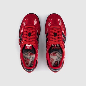 Adidas x Coca-Cola red and black trainers, top-down view showing Coca-Cola branded uppers, black stripes, and printed insoles