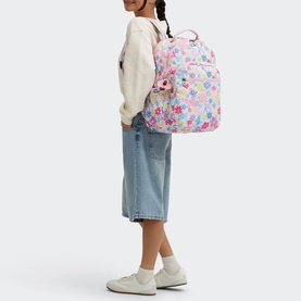 Model carrying Kipling Seoul Lap Backpack in Flower Stamp print, worn on back, styled with cream sweatshirt and blue midi skirt