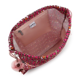 Kipling bag interior in U R Great Prt print, showing pink zip pocket lining, monkey keyring charm, and bold graphic pattern trim.