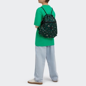 Model carrying Kipling Supertaboo Gym Bag in Soccer Prt, dark green floral print drawstring backpack, worn with green tee and light blue jeans