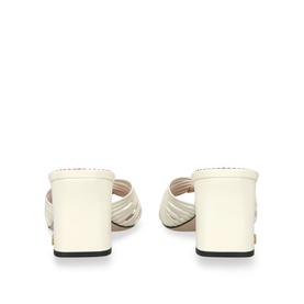 Valentino white leather block heel mule sandals with crossover straps, viewed from the back, black rubber sole visible.