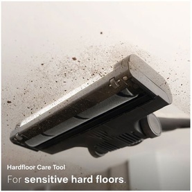 Hardfloor Care Tool attachment close-up, covered in dust and debris, demonstrating use on sensitive hard floor surfaces.