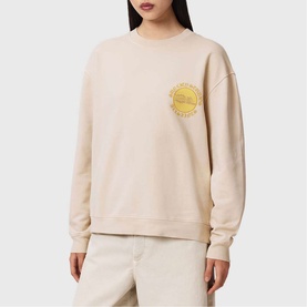 Model wearing All Saints Sun City Etta Sweatshirt in Birch White with yellow sun screen-print, styled with matching trousers.