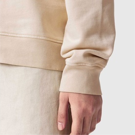 Model wearing All Saints Sun City Etta Sweatshirt in Birch White, close-up of ribbed cuff detail on 100% cotton fabric