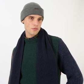 Model with Barbour Healey Logo Badge Beanie Hat in charcoal, double-knit turn-up brim, styled with navy ribbed scarf and jumper.