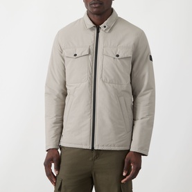 Model wearing Barbour International concrete casual jacket with zip front, chest pockets and arm badge, styled with khaki trousers