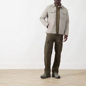Model wearing Barbour International concrete casual jacket, styled with olive cargo trousers and green trail trainers