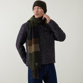 Model with Barbour Westerdale Beanie Hat & Scarf Gift Set in green; check boucl&eacute; scarf with tasselled hem, styled with dark speckled jacket