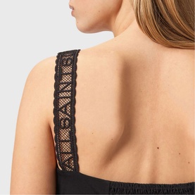 Model wearing All Saints Celena Logo Strap Top in black, close-up of lace logo-embroidered strap and smocked back panel detail.