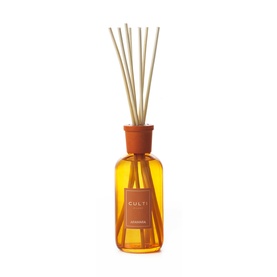 Culti Milano reed diffuser in amber glass bottle with terracotta cap and label, featuring multiple natural rattan sticks