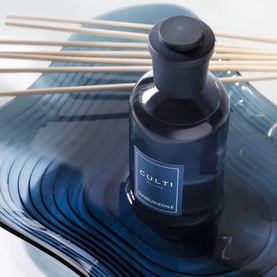 Culti Milano reed diffuser in smoky blue glass bottle with black collar and natural reed sticks