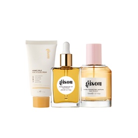 Gisou Hair Care Set featuring honey hair oil with dropper, perfume spray bottle, and cream tube in gold and pink packaging