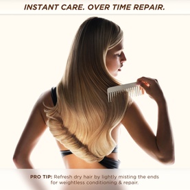 Model with long blonde hair being combed, styled using Gisou Honey Milk Active Repair Leave-In Conditioner for weightless conditioning and repair.