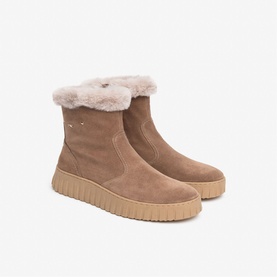 Brown suede ankle boots with fluffy shearling cuff trim and cream ridged platform sole, pair shown together