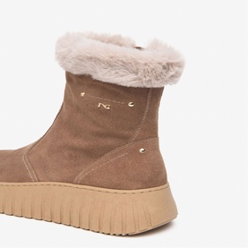 Brown suede ankle boot with faux fur cuff trim, gold logo studs, and chunky beige rubber sole