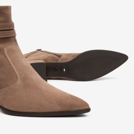 Brown suede ankle boots with pointed toe, ruched shaft detail, and dark brown flat sole, shown from side and sole angles