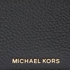 MMK Jet Set Logo Zip Cardholder in black pebbled leather with gold-toned Michael Kors logo lettering, close-up detail shot.