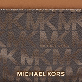 MK brown and acorn monogram logo cardholder with gold-tone branding, close-up detail showing signature MK pattern and leather trim