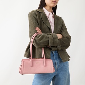 Model carrying MMK Laila Tote Bag in Primrose suede with gold-toned hardware and top handles, styled with khaki jacket and jeans