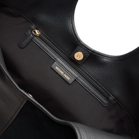 MMK black leather tote bag interior, showing zip pocket, gold-tone hardware and branded label against black fabric lining