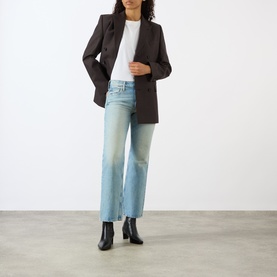 Model wearing Mother Straight jeans in Daydreamer light blue wash with a dark blazer and black ankle boots.