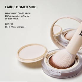 Duo Brush 2.0 large domed side shown with fluffy brush head resting on open compact, demonstrating soft diffusing application