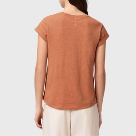 Model wearing All Saints Anna Back Logo T-Shirt in Pecan Brown, short sleeves with turn-back cuffs, crew neck, styled with cream wide-leg trousers