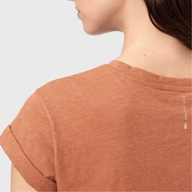 Model wearing All Saints Anna Back Logo T-Shirt in pecan brown, showing back detail with turn-back cuffs and logo screen print branding.