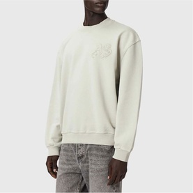Model wearing light grey crew neck sweatshirt with tonal chest logo embroidery, styled with grey washed jeans