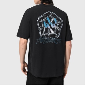Model wearing black oversized T-shirt, back view showing large metallic fist graphic with blue detail and branded script logo print.