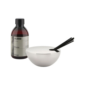 Alessi Diffuser Set in Flint, featuring a polished stainless steel canister with lid, black rattan reeds, and amber glass refill bottle.