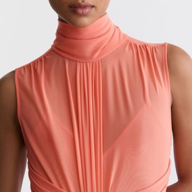 Model wearing Reiss coral orange sleeveless turtleneck dress with pleated front detail and draped neckline.