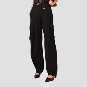 Model wearing Maje red wide-leg cargo trousers with side pockets and silver button details, styled with a black belt and burgundy heels.
