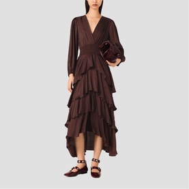 Model wearing chocolate brown long-sleeve V-neck tiered ruffle midi dress, styled with burgundy patent bag and strappy flat shoes
