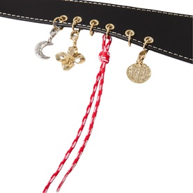 Claude Pierlot black belt with gold-tone hardware, crystal moon charm, floral charm, coin charm and red braided tassel detail