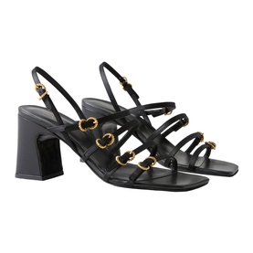 Claude Pierlot black leather strappy block heel sandals with gold horsebit hardware, ankle strap, and square toe, side view