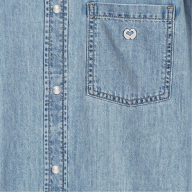 Maje light blue denim shirt close-up showing chest patch pocket with heart logo badge and snap button placket detail