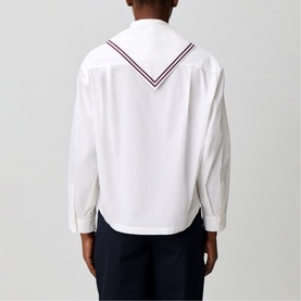 Model wearing Claude Pierlot white cotton shirt, back view, with navy V-neck sailor collar trim in red and navy stripe detail, styled with dark