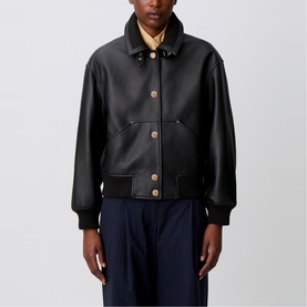 Model wearing Claude Pierlot Leather Bomber Jacket in black, gold-tone press studs, patch pockets, ribbed cuffs and hem, styled with navy trousers
