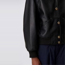 Claude Pierlot Leather Bomber Jacket in black lambskin, close-up of gold-tone press studs, riveted patch pocket, and ribbed cuff detail