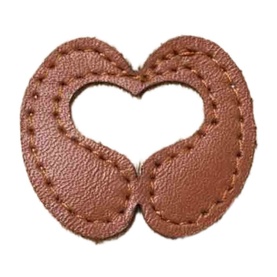Maje tan faux-leather heart-shaped patch with stitched edges and cut-out heart centre detail