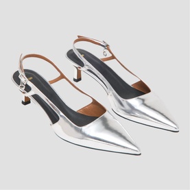Maje silver mirrored pointed-toe slingback heels with tan leather ankle strap and kitten heel, duo flat-lay view
