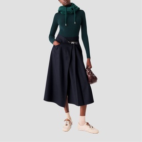 Model wearing Maje Womens French Dress in multi, styled with cream trainers and carrying a small brown bag